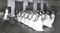 Historical photo of Anna Maxwell teaching nurses.